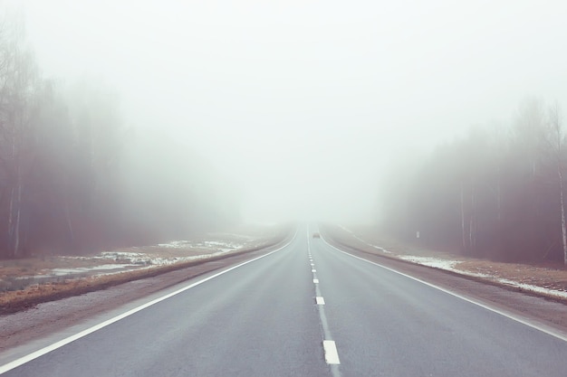 road in fog concept, mist in october halloween landscape, highway