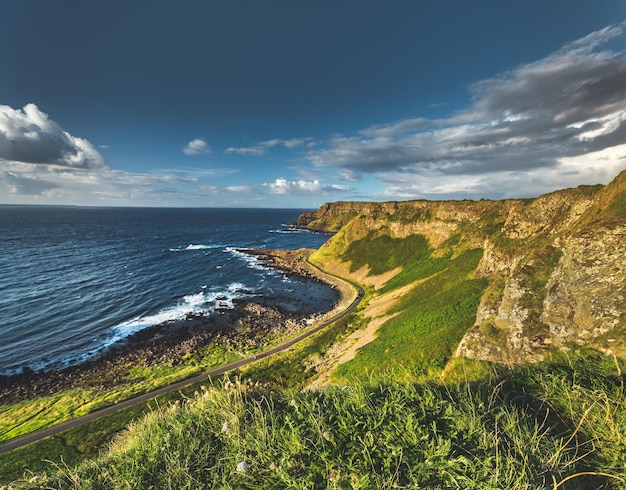 The road passing through the northern ireland shoreline breathtaking irish landscape grass covered