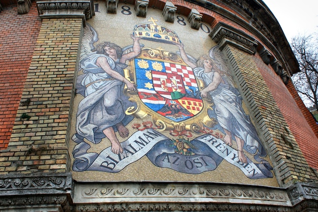 Road to Royal Palace with ancient mosaic Coat of Arms on Castle Hill wall in Budapest Hungary