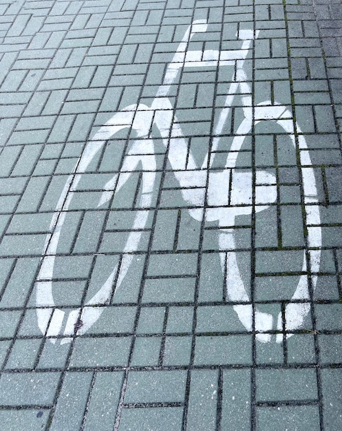 Road sign Bike path  on asphalt in white with copyspace