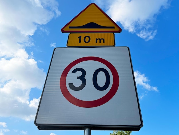 Road sign Speed limit and Speed bump on the background of blue sky with copyspace