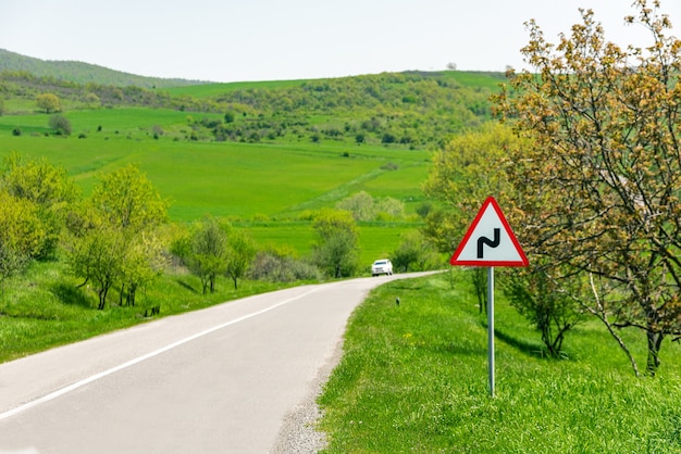 Road sign, winding road