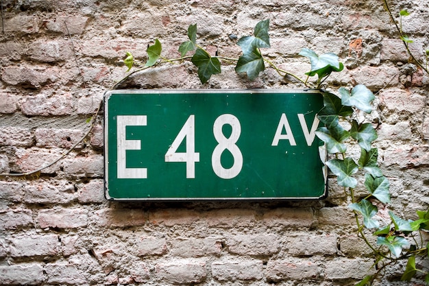 Road sign with E 48 av on green background