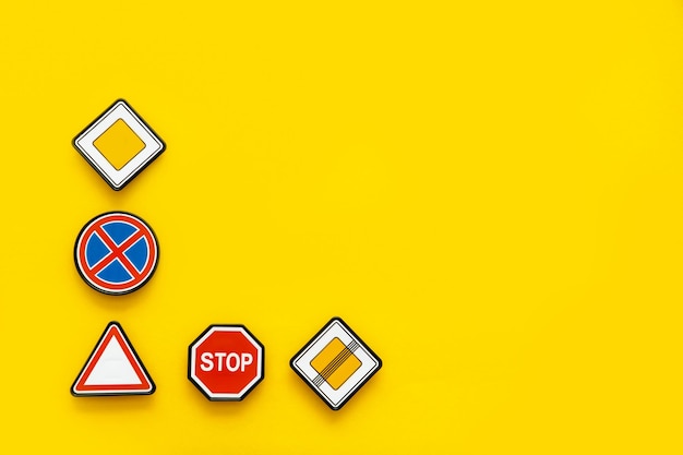 road signs on yellow background with copy space