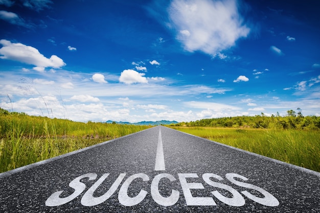 Road to success concept with 3d rendered success text on asphalt road