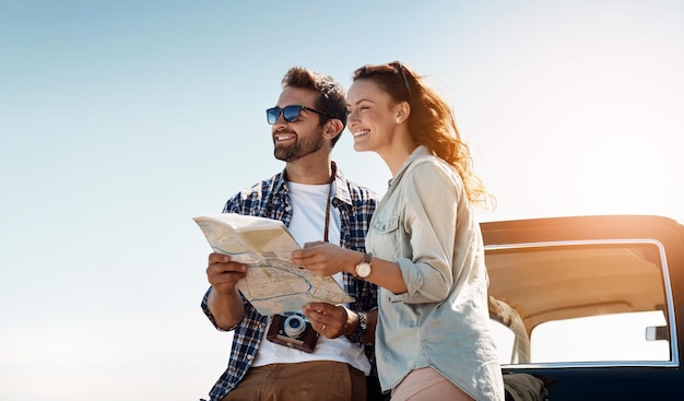 Road trip couple and map outdoor for destination location search and navigation for travel Happy people man and woman with paper for guidance direction and instructions for adventure journey