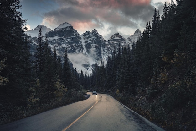 Road trip with Rocky Mountains in pine forest near Moraine Lake at Banff national park, Canada