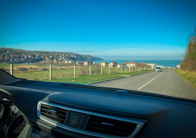 Road view through the car window at the ocean