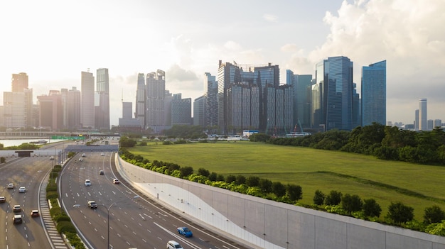 Road with landmark buildings in Singapore Road to Singapore downtown Car with Singapore cityscape skyline during sunset