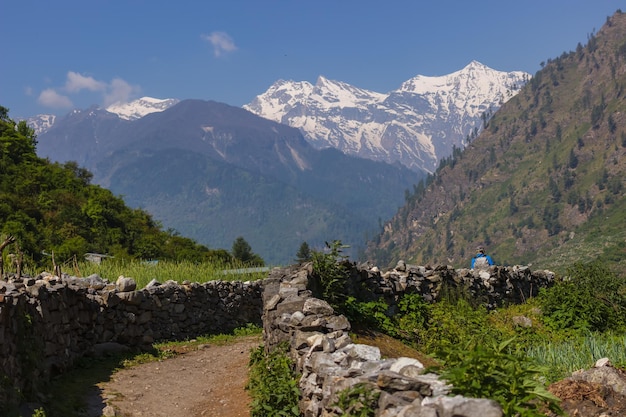 Road with stone fence in a mountain valley in the Himalayas