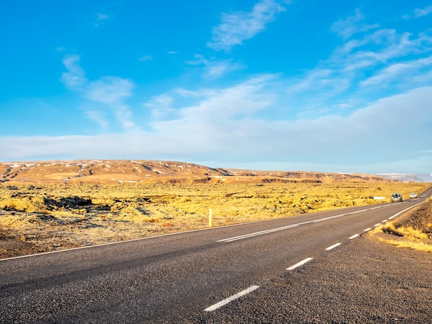 Road with surrounding view of nature in Iceland mountain and field