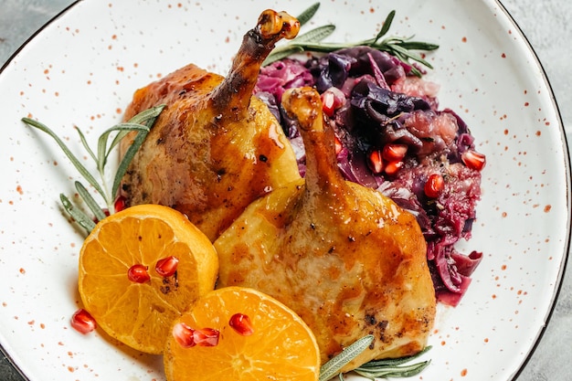 Roast duck leg red cabbage homemade with rosemary and oranges Food recipe background Close up