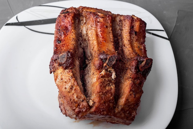 Roast pork loin on a white plate