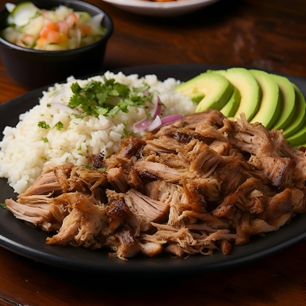 Roast pork with rice and avocado on a black plate close up