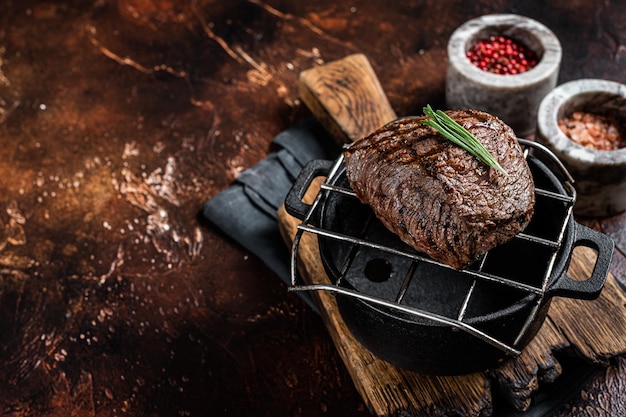 Roast Rump sirloin steak with spices on a grill Dark background Top view Copy space