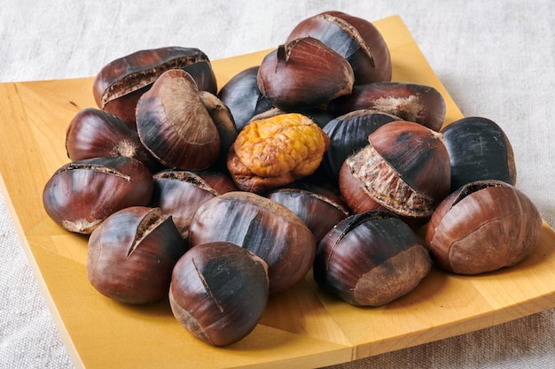 Roasted chestnuts on wooden plate