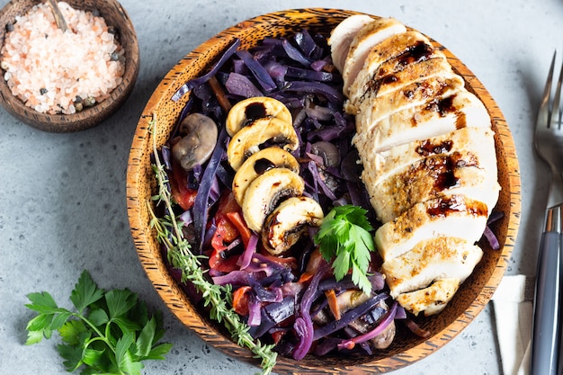 Roasted chicken breast and stewed red cabbage with mushrooms and tomatoes