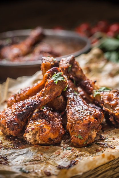 Roasted chicken legs barbecue on baked paper - Close-up.