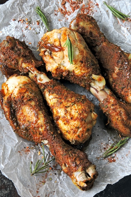 Roasted chicken legs on paper. Grilled chicken legs.