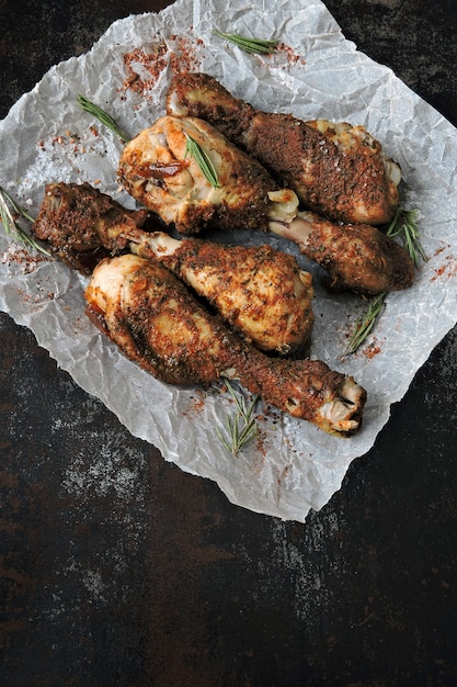 Roasted chicken legs on paper. Grilled chicken legs.