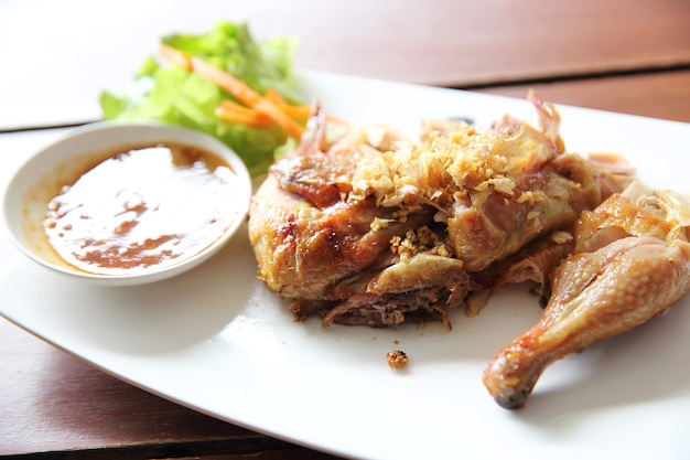 Roasted chicken in wood background