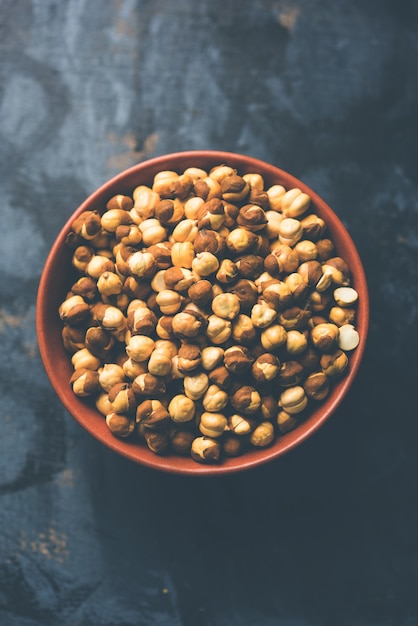 Roasted Chickpea or chana known as futana or Phutana in Hindi served in a bowl or over gunny bag. Selective focus