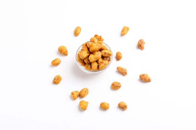 Roasted coated peanuts on white background Delicious snack peanut