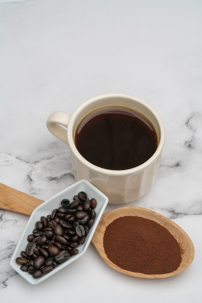 Roasted coffee beans, ground coffee, Cup of coffee, Wooden spoon with roasted coffee