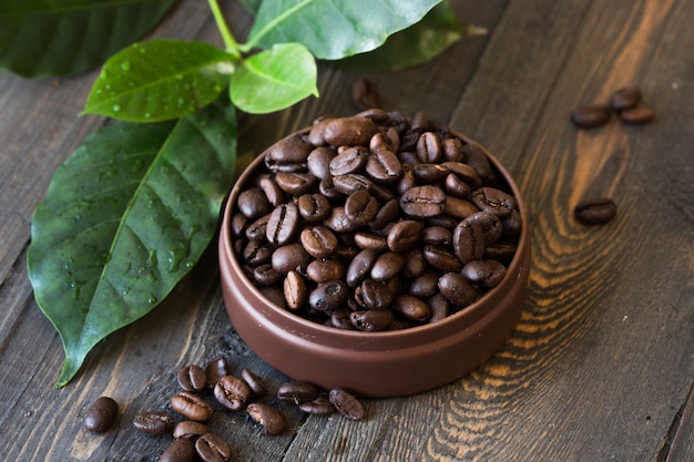 Roasted coffee beans, ground coffee on wooden table. Top view.