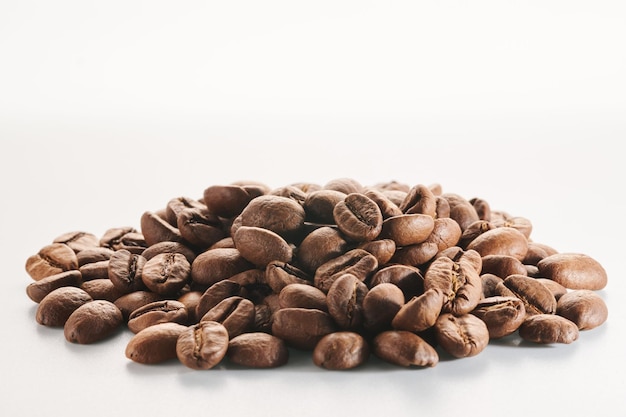 Roasted coffee beans isolated close up on white background clipping path