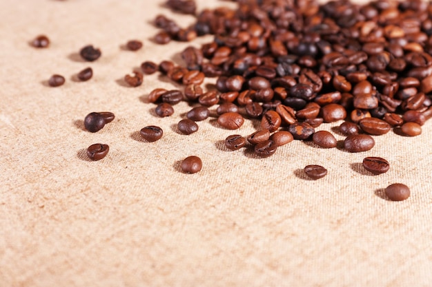 Roasted coffee beans on the linen fabric