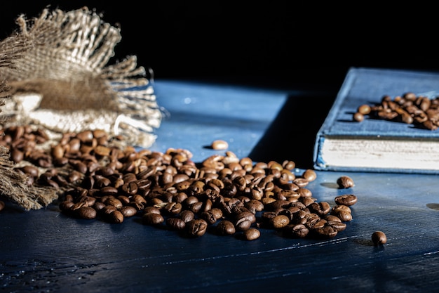 Roasted coffee beans on a navy blue background