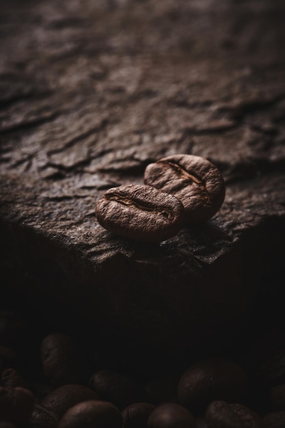 Roasted coffee beans on stone pedestal brown background