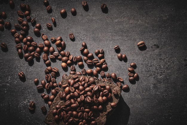 Roasted coffee beans on stone pedestal gray background