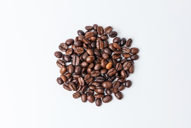 Roasted coffee beans on white background