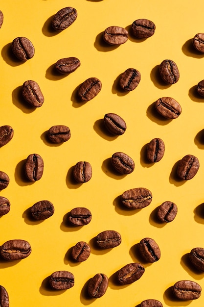 Roasted coffee beans on yellow background