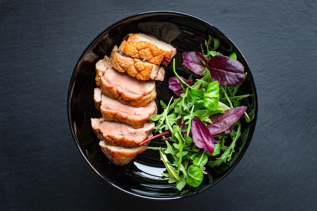 Roasted duck breast and salad leaves grill or barbecue meat poultry portion