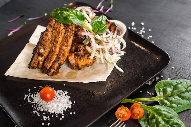 Roasted edges with vegetables on wooden background