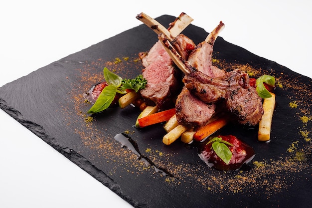 Roasted lamb rack served with carrot yellow curry and lamb sauce