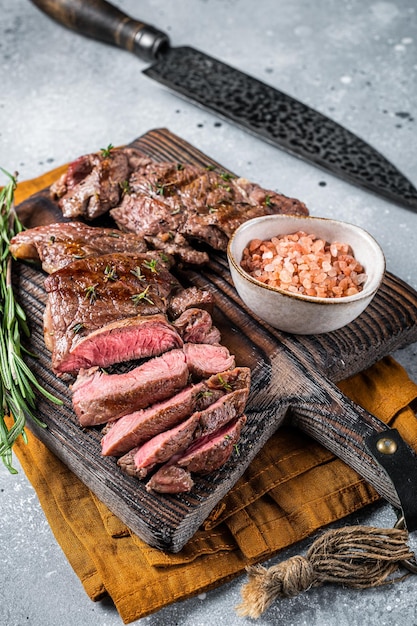 Roasted Mutton leg steaks sliced lamb meat Gray background Top view