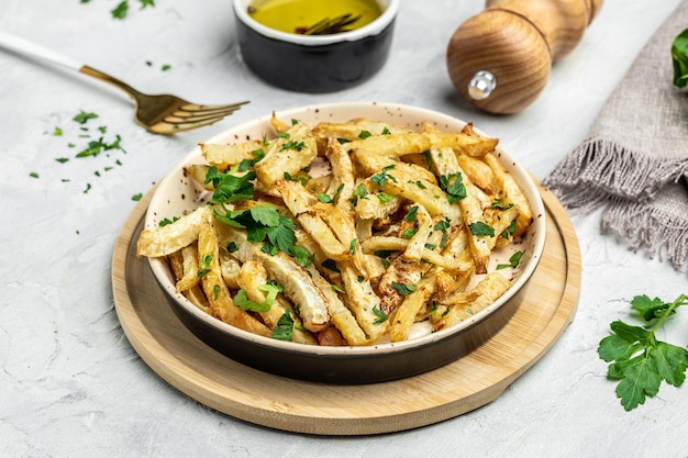 Roasted Parsnips on light Background side dish on plate Delicious vegetarian breakfast or snack Clean eating dieting vegan food concept top view