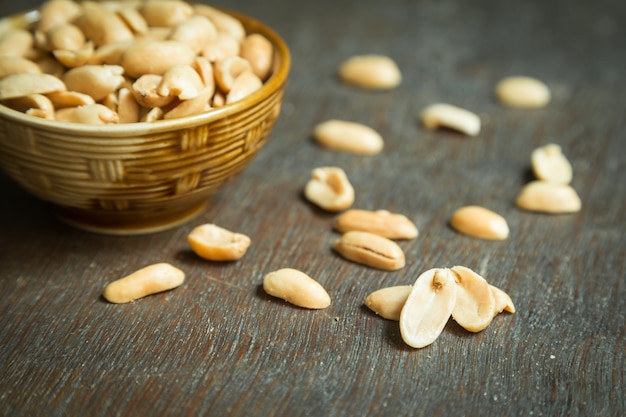 Roasted peeled salted peanuts in rustic bowl 