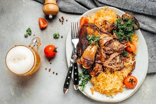 Roasted pork knuckle eisbein with sauerkraut and beer Traditional dish in German cuisine schweinshaxe