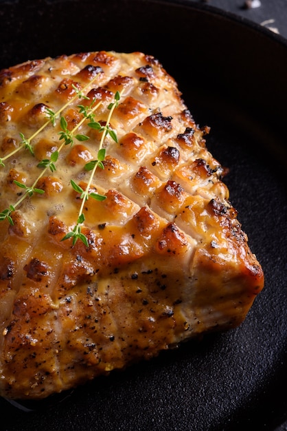 Roasted pork sirloin on a black iron pan