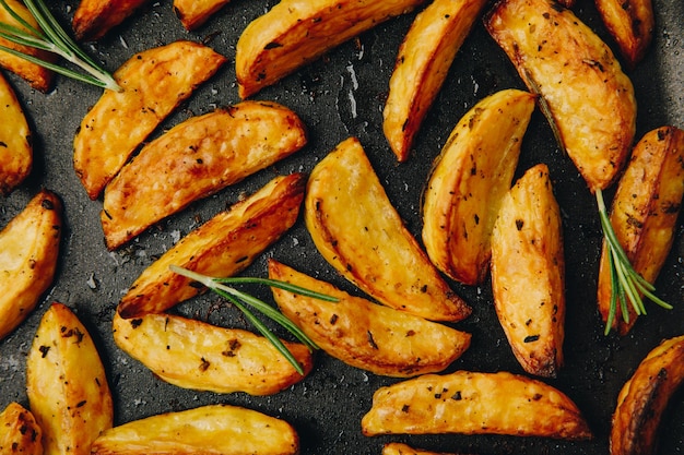 Roasted potatoes Baked potato wedges with rosemary Top view