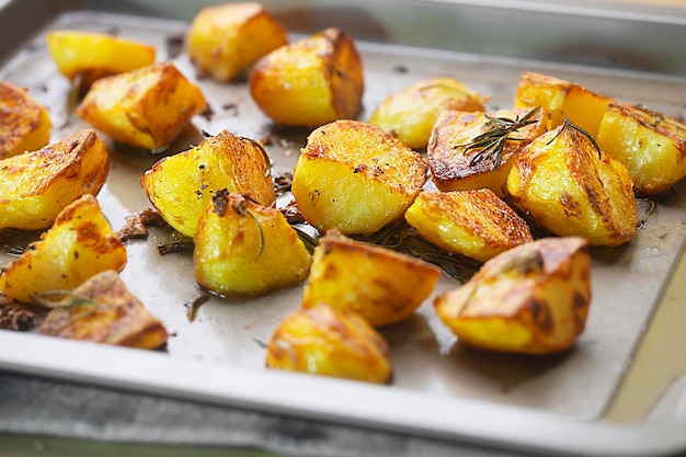 Roasted potatoes on the baking sheet with garlic and rosemary