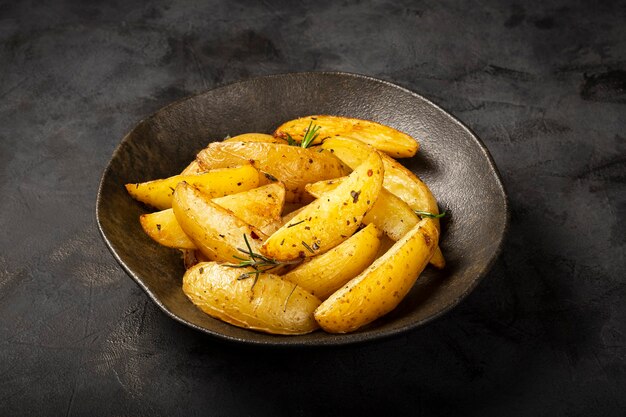 Roasted potatoes with rosemary on the plate