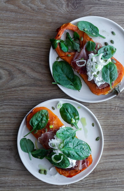 Roasted pumpkin with ricotta cheese, serrano ham, spinach and onion