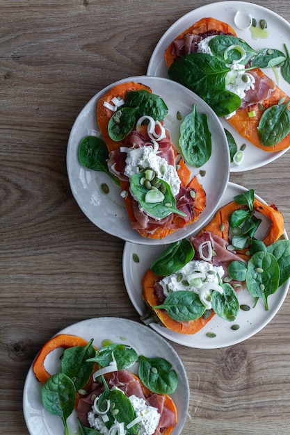 Roasted pumpkin with ricotta cheese, serrano ham, spinach and onion