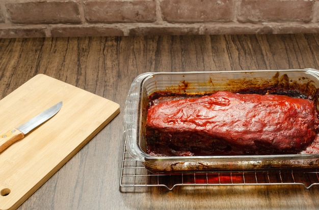 Roasted ribs marinated with barbecue sauce on wooden table